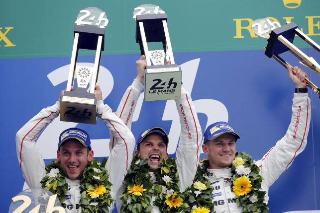 Porsche 919 Hybrid number 19 driver Tandy of Britain, Bamber of New Zeland, and Hulkenberg of Germany celebrate on the podium after winning the Le Mans 24-hour sportscar race in Le Mans, central France